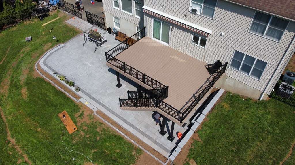 Aerial view of WOLF PVC deck with black RDI railings and patio in Bridgewater New Jersey